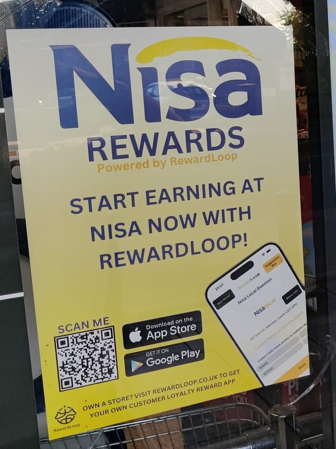 A RewardLoop poster in a convenience store window