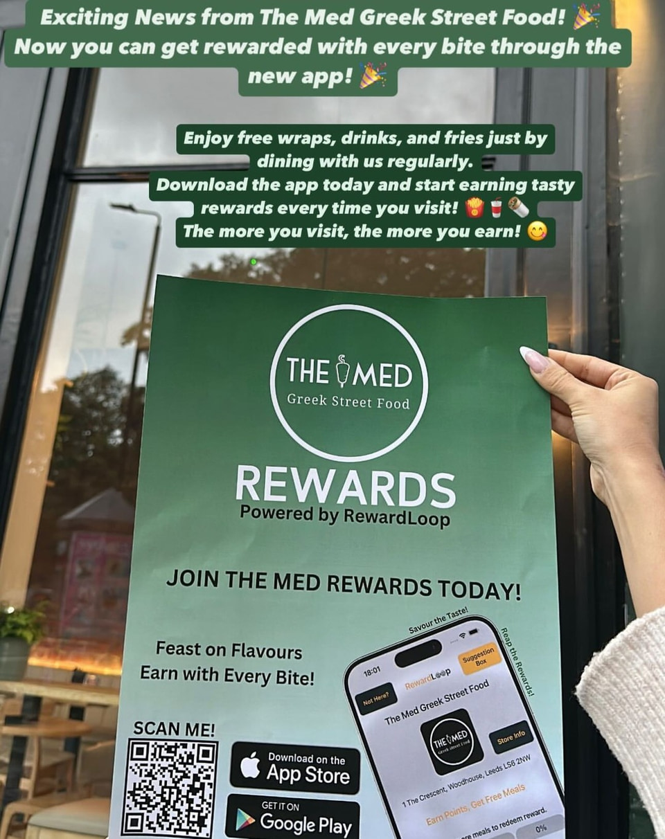 The Med owner holding a newly arrived RewardLoop launch poster